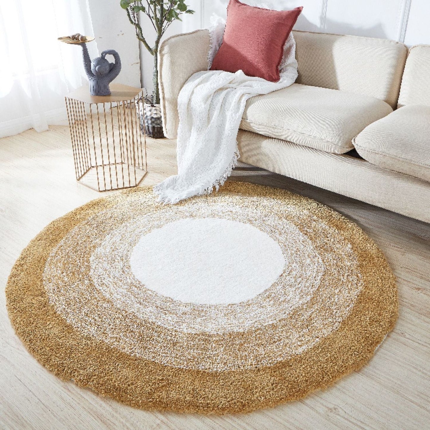 Round beige rug with concentric circles in a living room setting.