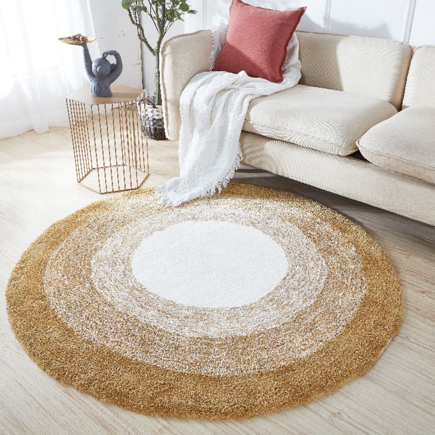 Round beige rug with concentric circles in a living room setting.